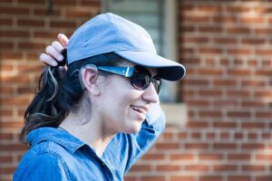 krystal alexandria in front of a brick wall with sunglasses and a hat on